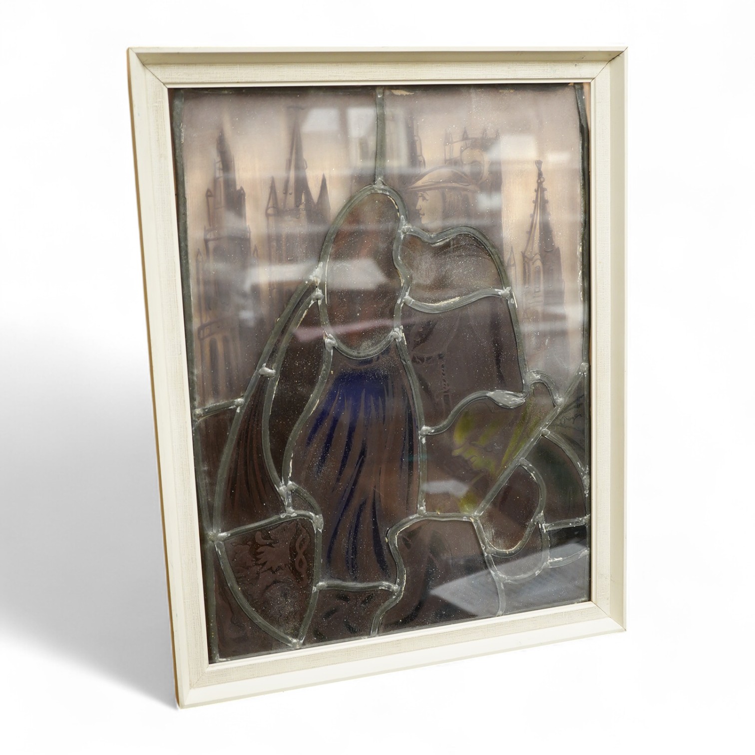 A stained and leaded glass panel of a romantic couple in front of a cathedral, 48cm high